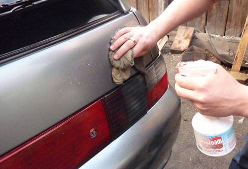 Removing adhesive tape from a car