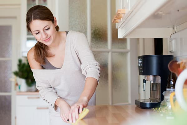 Girl cleaning the kitchen