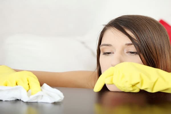 Girl wipes a polished countertop