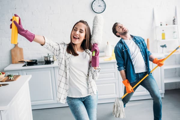 Young couple having fun while cleaning.