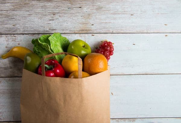 Paper bag with vegetables and fruits.